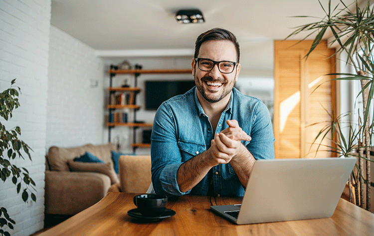 Young man sitting at home at his desk