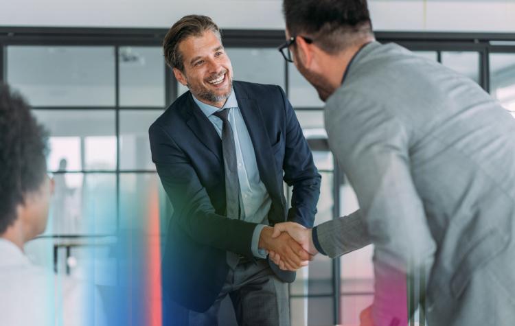 Two employees shaking hands